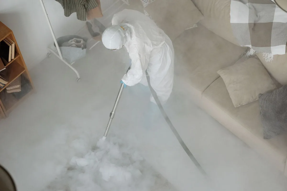 Biohazard cleanup technician in protective equipment, Logan, IA